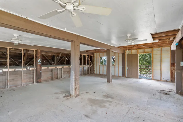 a view of an empty room with balcony and floor to ceiling window