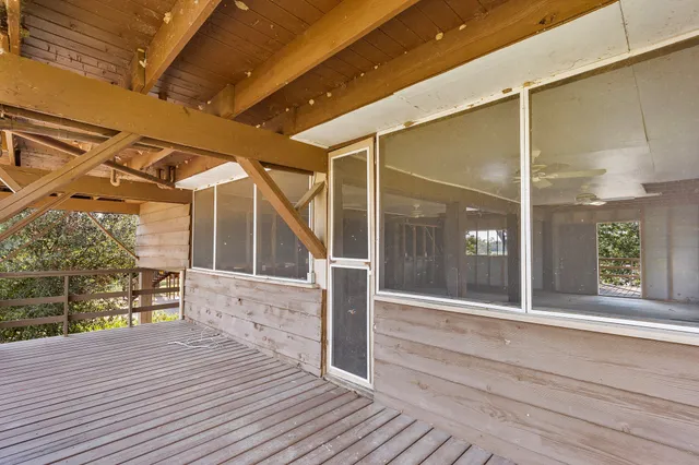 an empty room with wooden floor and a sink