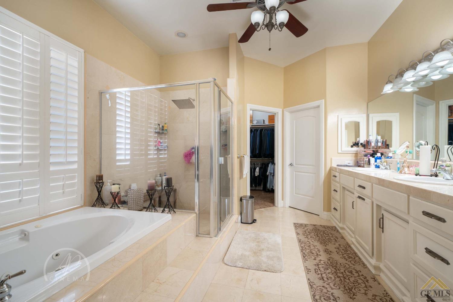 Undisclosed Address Bakersfield, CA 93311 - Photo 15 of 33 a spacious bathroom with a tub sink a mirror a shower and vanity