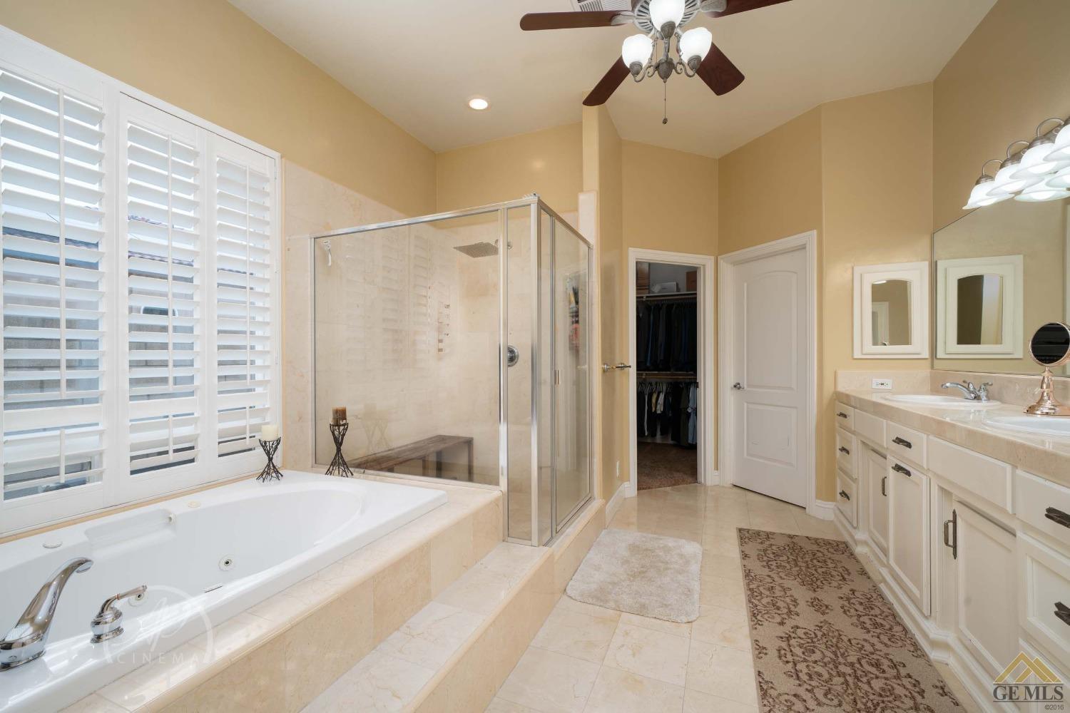 Undisclosed Address Bakersfield, CA 93311 - Photo 16 of 33 a bathroom with a tub sink and mirror