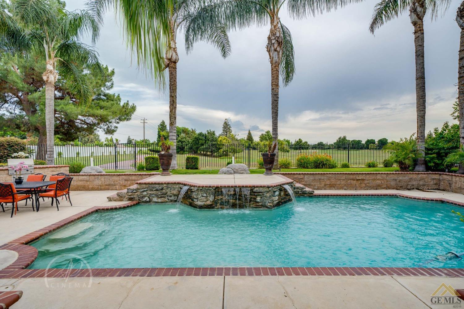 Undisclosed Address Bakersfield, CA 93311 - Photo 26 of 33 a view of a swimming pool with a patio and a yard