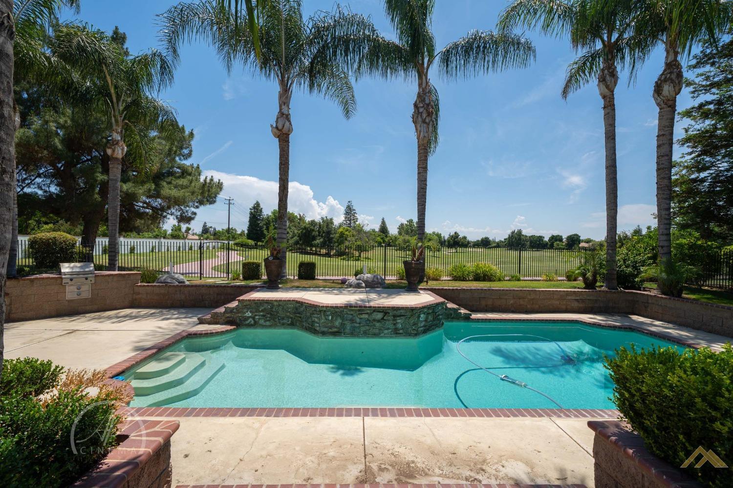 Undisclosed Address Bakersfield, CA 93311 - Photo 3 of 33 a view of a swimming pool and a garden