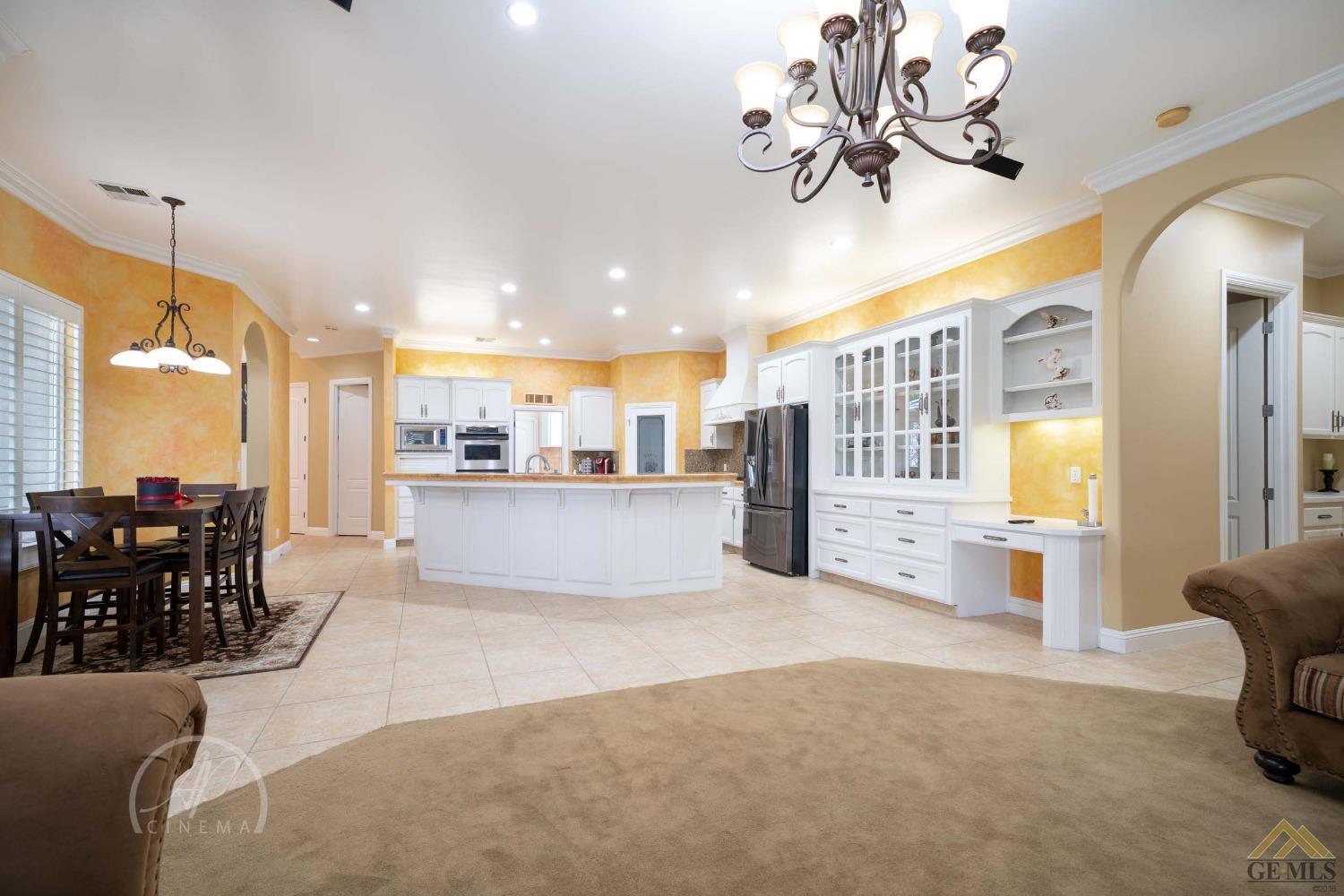 Undisclosed Address Bakersfield, CA 93311 - Photo 4 of 33 a living room with stainless steel appliances kitchen island granite countertop furniture and a chandelier