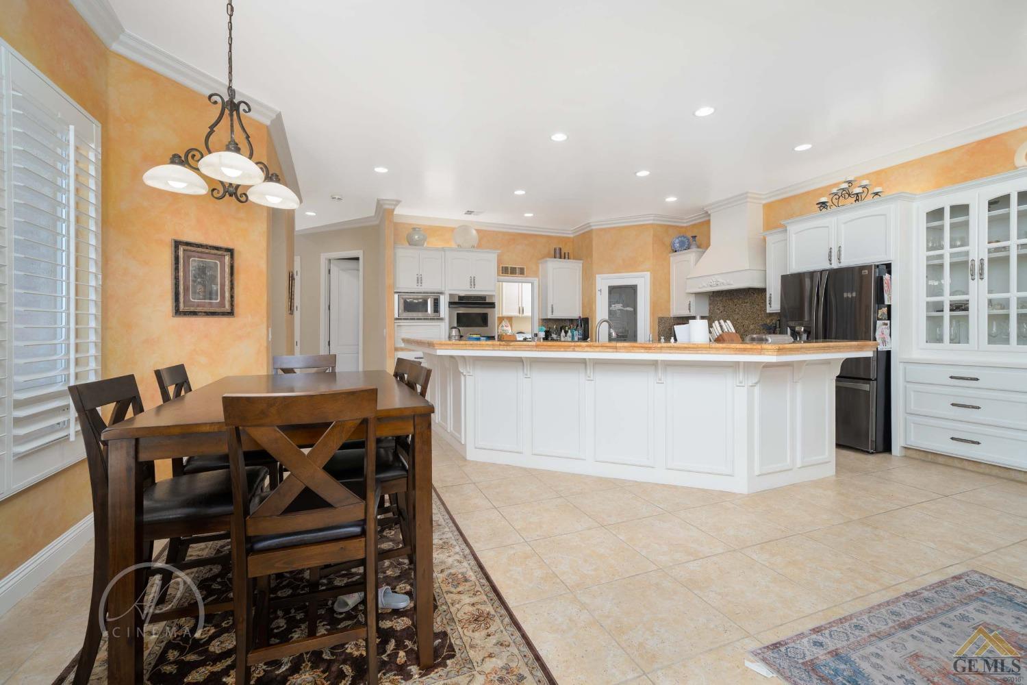 Undisclosed Address Bakersfield, CA 93311 - Photo 6 of 33 a large kitchen with a table and chairs