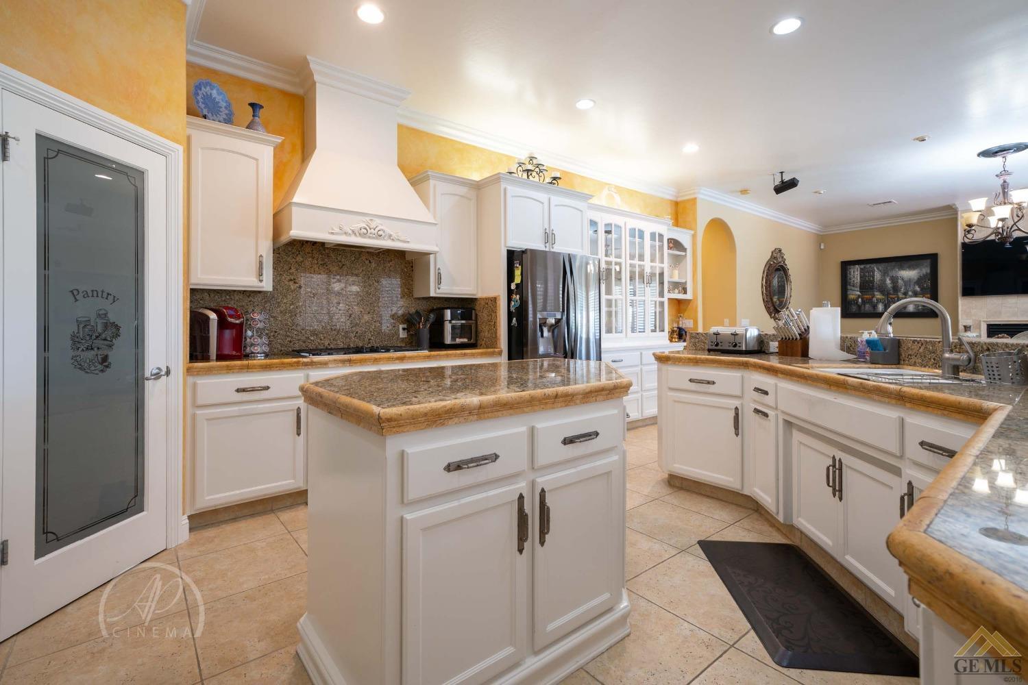 Undisclosed Address Bakersfield, CA 93311 - Photo 7 of 33 a kitchen with white cabinets and appliances