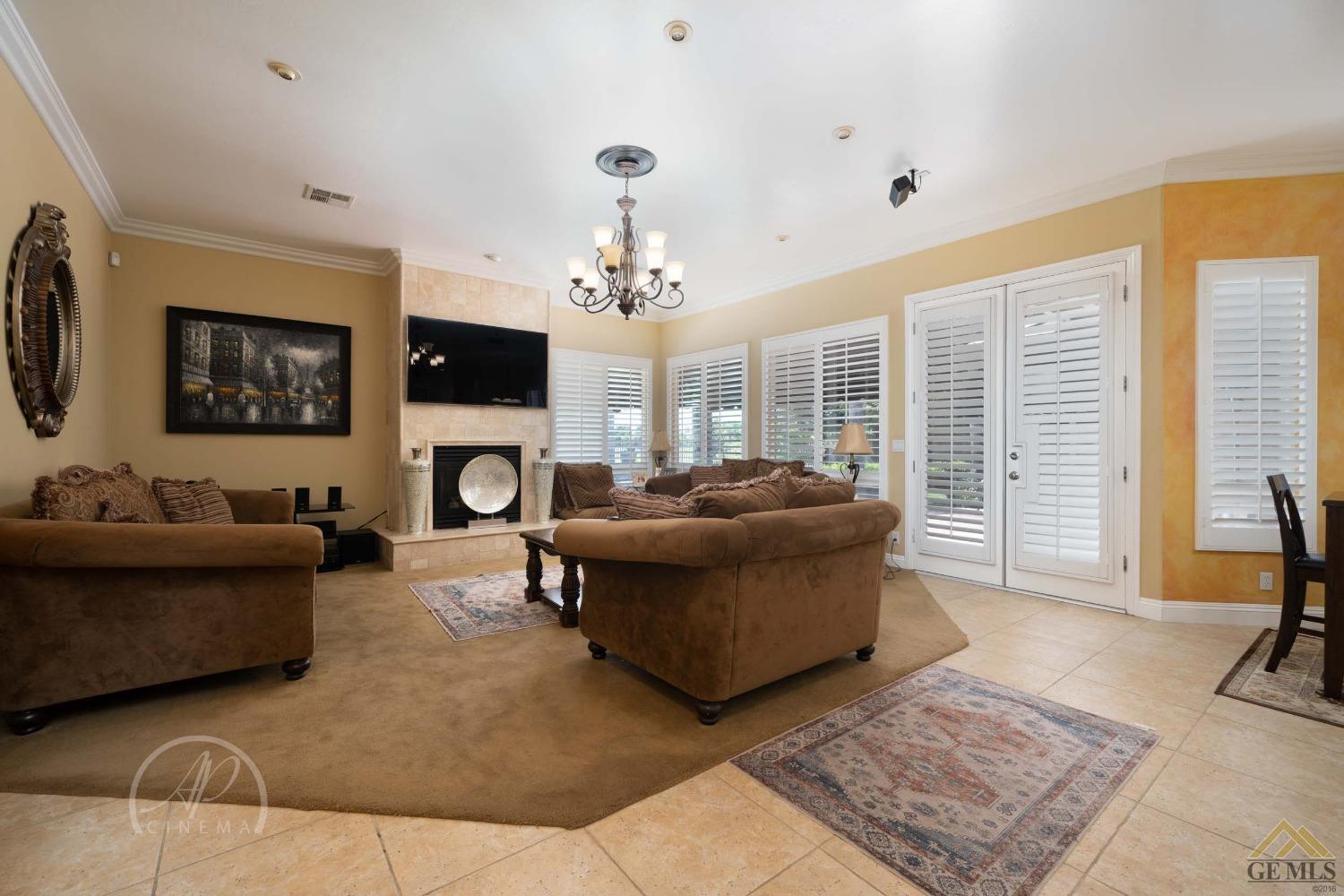 Undisclosed Address Bakersfield, CA 93311 - Photo 9 of 33 a living room with furniture a fireplace and a flat screen tv