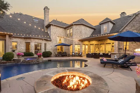 a view of a house with swimming pool and sitting area