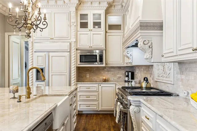 a kitchen with stainless steel appliances granite countertop a sink and cabinets