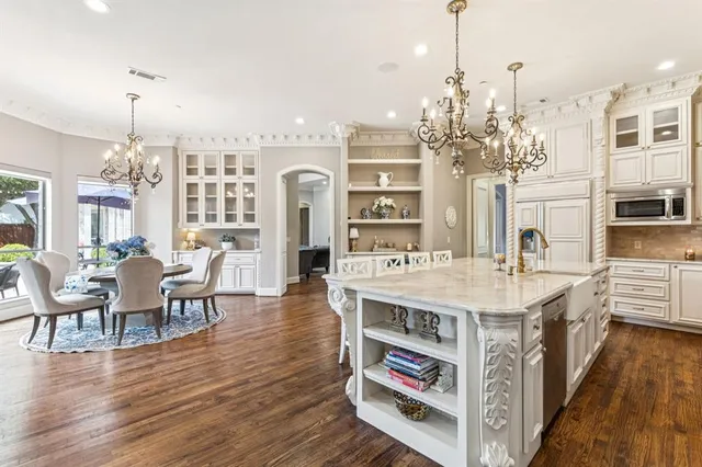 a large kitchen with a table and chairs