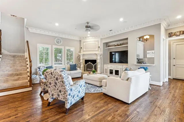a living room with fireplace furniture and a flat screen tv