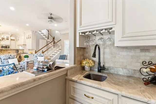 a close view of a sink and dishwasher with kitchen island