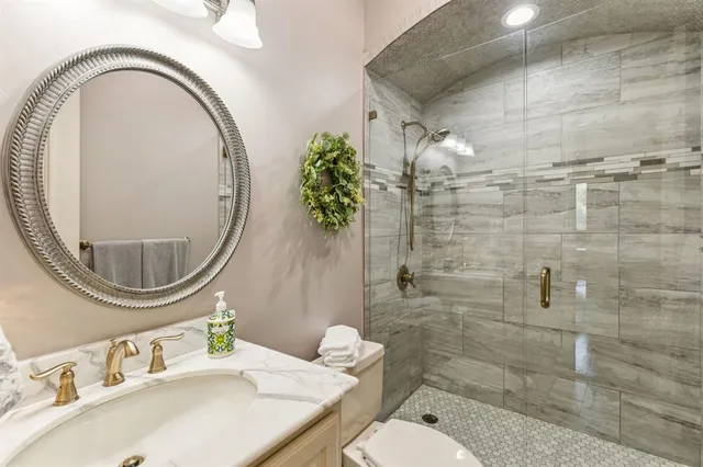 a bathroom with a sink a toilet and a mirror