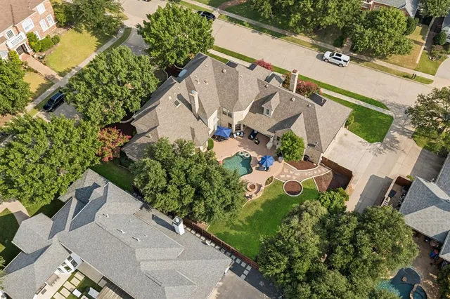 an aerial view of a house with a yard and garden