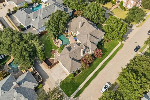 an aerial view of residential house with outdoor space and swimming pool