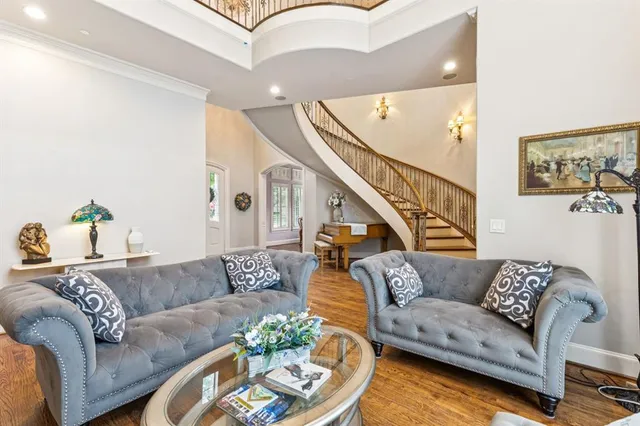a living room with furniture and stairs