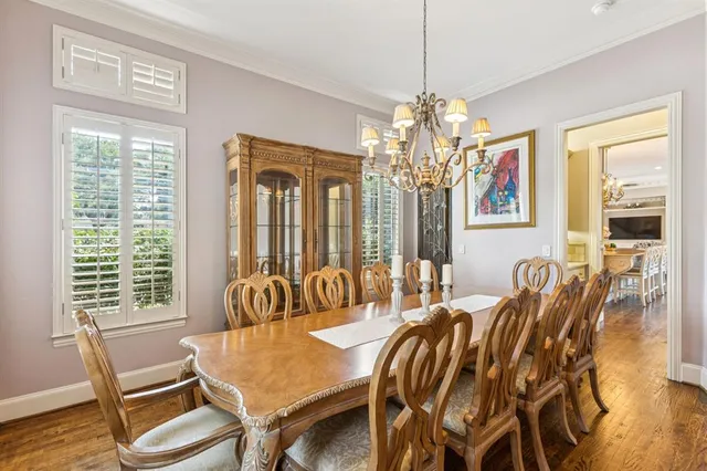 a view of a dining room with furniture and chandelier