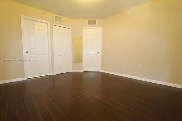 an empty room with wooden floor