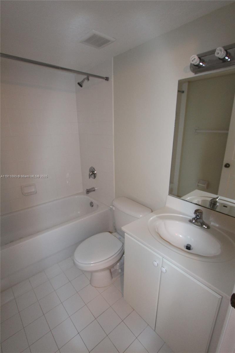 22801 Southwest 88th Place, Unit 205 Cutler Bay, FL 33190 - Photo 20 of 36 a bathroom with a sink a toilet and shower