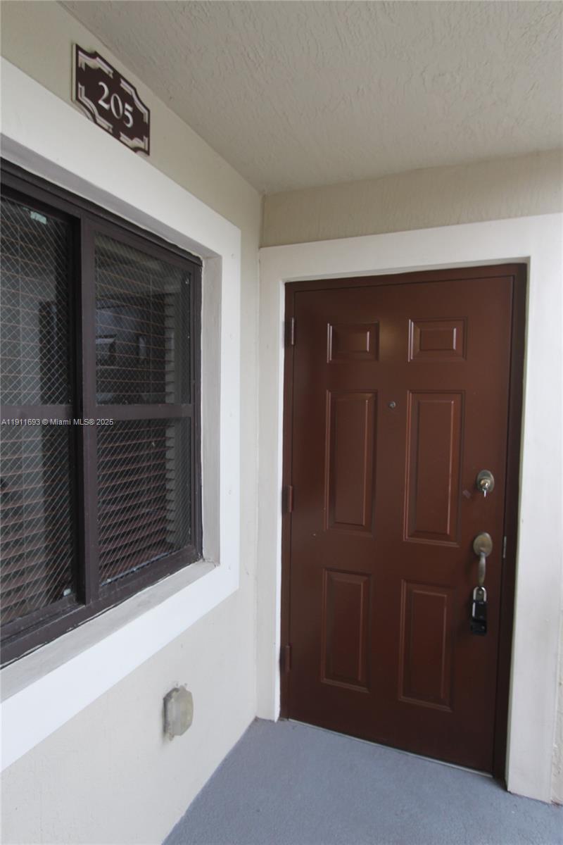 22801 Southwest 88th Place, Unit 205 Cutler Bay, FL 33190 - Photo 2 of 36 a view of wooden door
