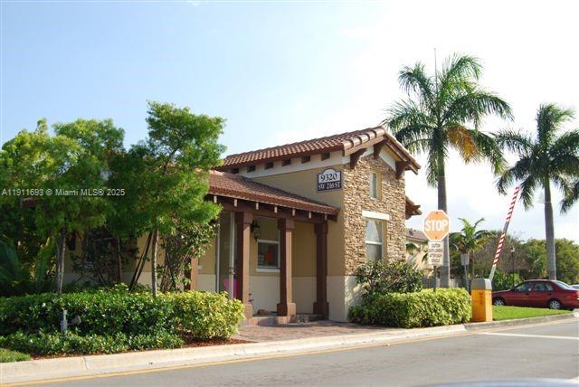 22801 Southwest 88th Place, Unit 205 Cutler Bay, FL 33190 - Photo 21 of 36 front view of a house with a garden