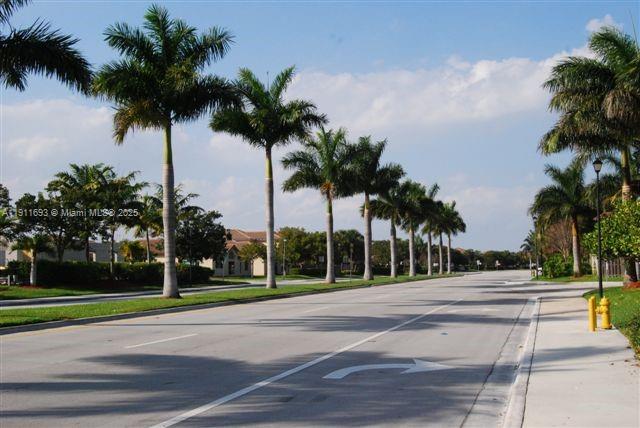 22801 Southwest 88th Place, Unit 205 Cutler Bay, FL 33190 - Photo 22 of 36 a view of a yard and palm trees
