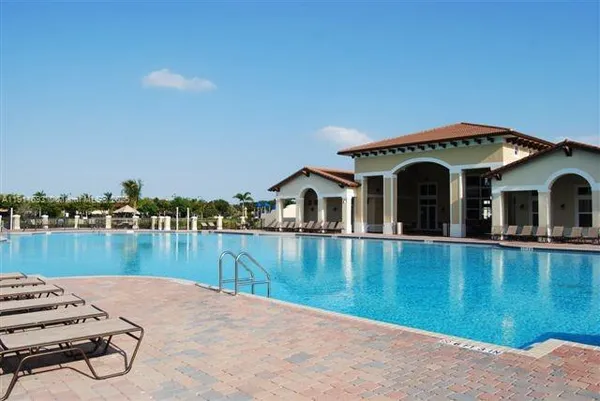 a view of a house with swimming pool and porch