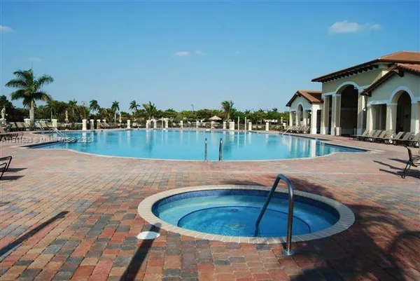 a view of a swimming pool with a patio and a garden