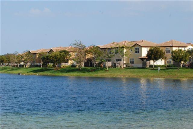 22801 Southwest 88th Place, Unit 205 Cutler Bay, FL 33190 - Photo 30 of 36 a view of building with river and trees in the background