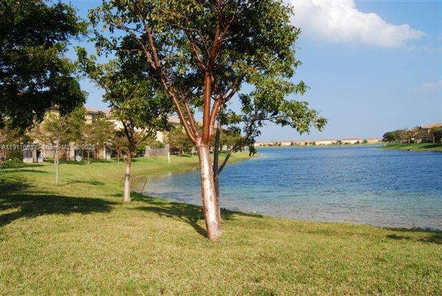 22801 Southwest 88th Place, Unit 205 Cutler Bay, FL 33190 - Photo 31 of 36 a view of a yard with an trees