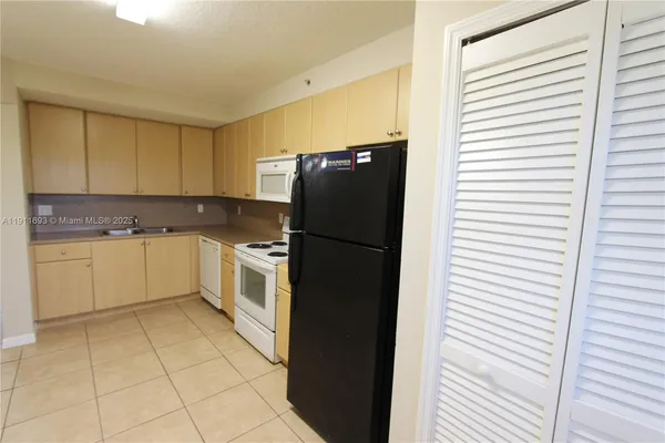 a kitchen with a stove a sink and a refrigerator