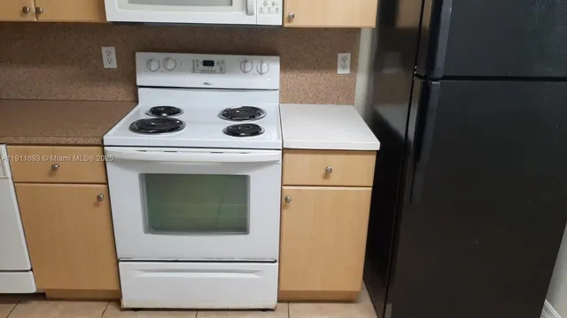 a kitchen with cabinets and white appliances