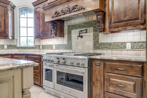 a kitchen with granite countertop a stove oven and sink