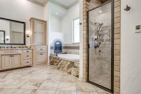 a bathroom with a tub sink and mirror
