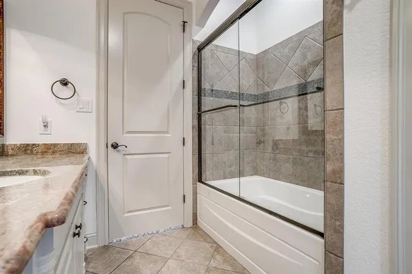 an empty room with chandelier fan