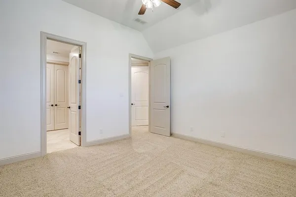 a bathroom with a granite countertop sink a toilet and a mirror