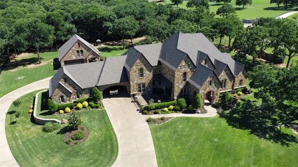 an aerial view of a house with swimming pool and garden