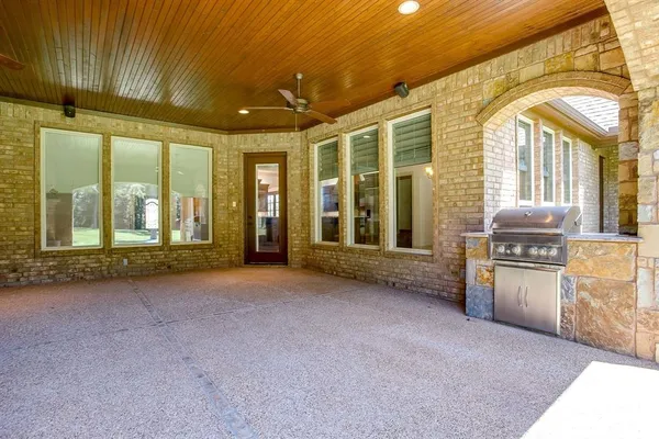 a view of an empty room with a fireplace and a window