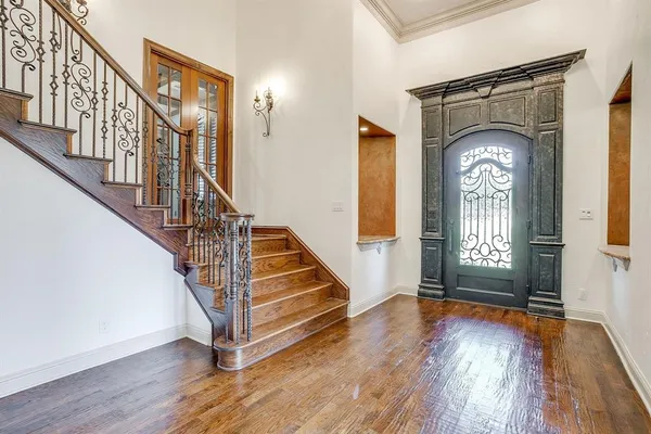 a view of a livingroom with wooden floor and stairs