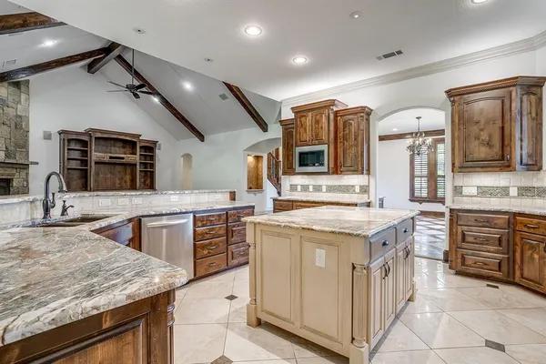 a kitchen with stainless steel appliances granite countertop a sink and cabinets