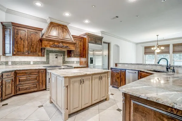 a kitchen with stainless steel appliances granite countertop a stove oven and a sink