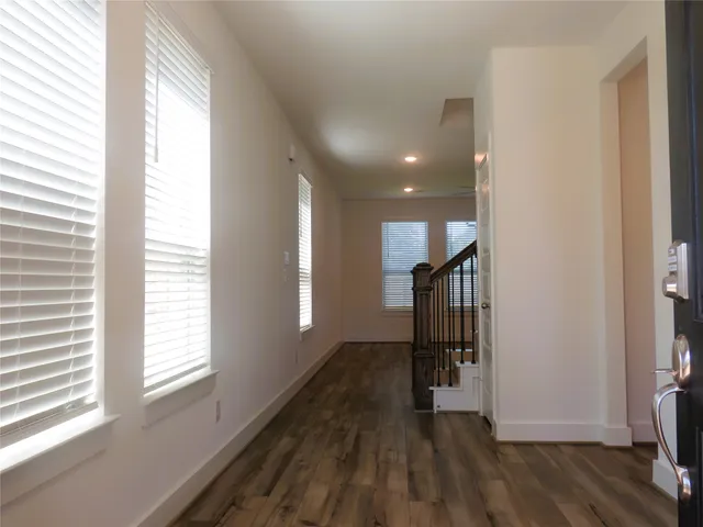 a view of entryway and hall with wooden floor