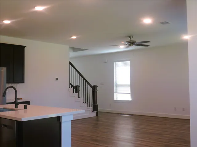 a view of kitchen with stainless steel appliances refrigerator stove microwave and cabinets