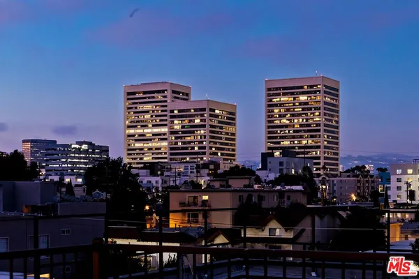 a front view of a residential apartment building with a yard