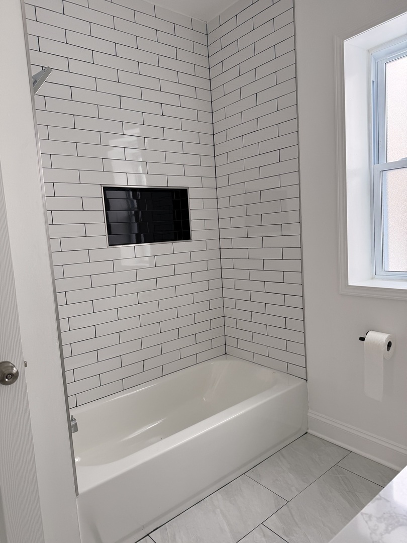 2101 Gunderson Avenue, Unit 2 Berwyn, IL 60402 - Photo 6 of 11 a bathroom with a bathtub and a shower