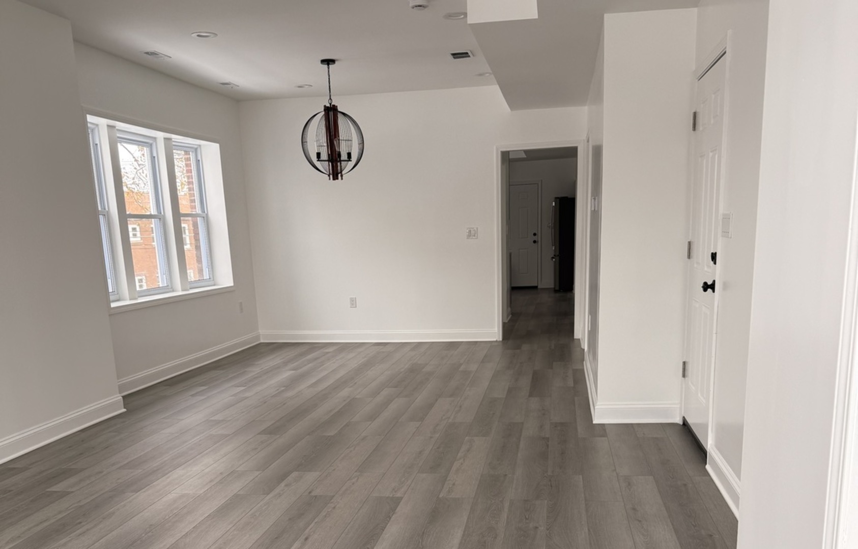 2101 Gunderson Avenue, Unit 2 Berwyn, IL 60402 - Photo 8 of 11 an empty room with wooden floor and windows