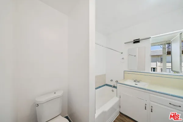 a room with a sink and wooden floor