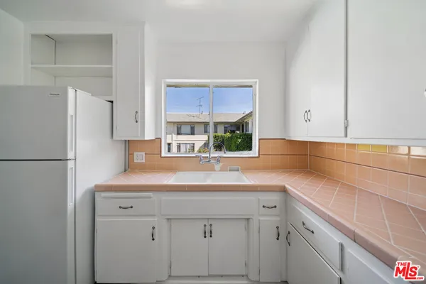a kitchen with a sink and a refrigerator