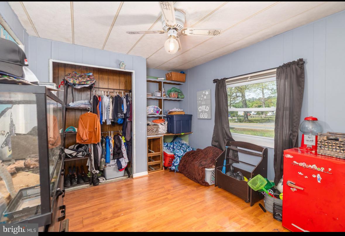 36372 Old Mill Road Ocean View, DE 19970 - Photo 9 of 14 a bed room with a bed mirror and a window