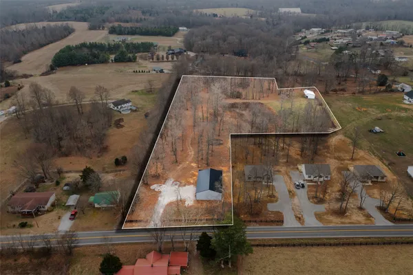 an aerial view of a residential houses with outdoor space