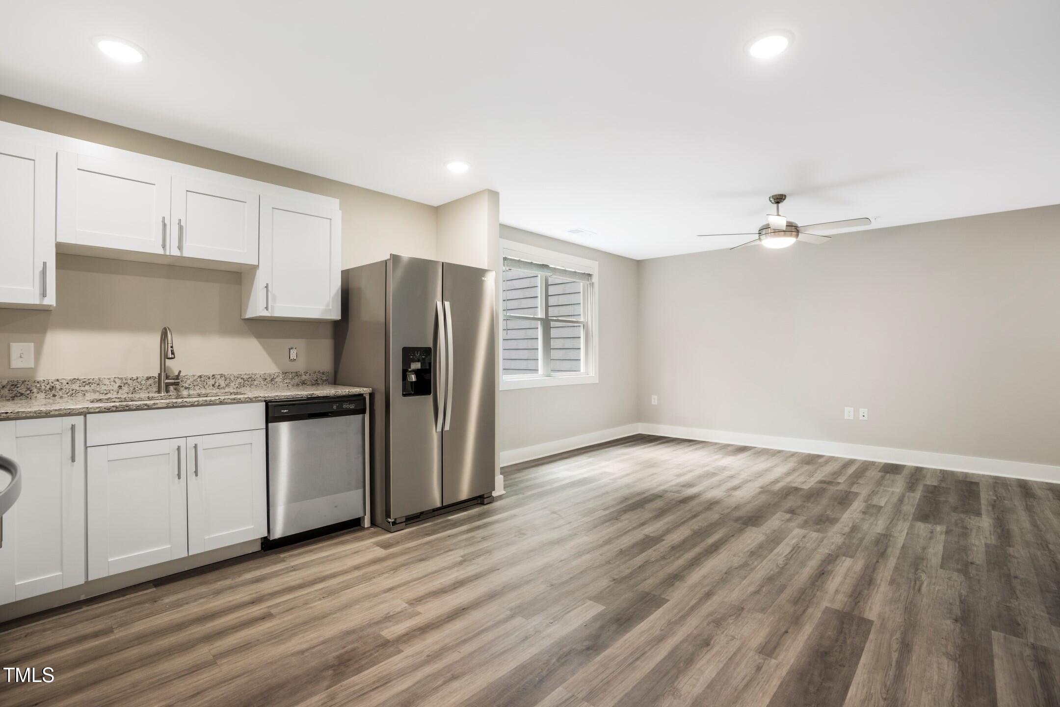303 Linwood Street, Unit 306 Apex, NC 27502 - Photo 11 of 19 a kitchen with granite countertop a refrigerator and a sink